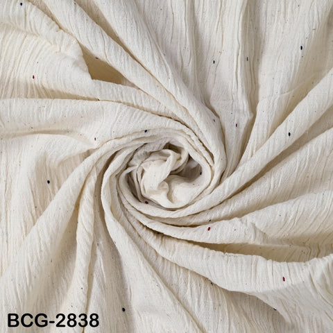 a close-up view of a white fabric with small black dots or specks scattered throughout it, creating a textured and visually interesting pattern.