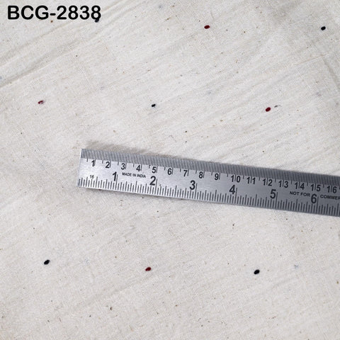 A ruler is placed on a white fabric surface, with the ruler's scale visible.
