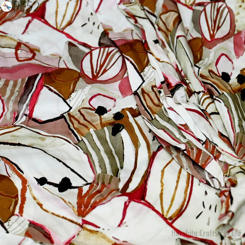 The image is a close-up of a fabric with a colorful, abstract pattern of shapes and lines in various shades of red, white, and brown.