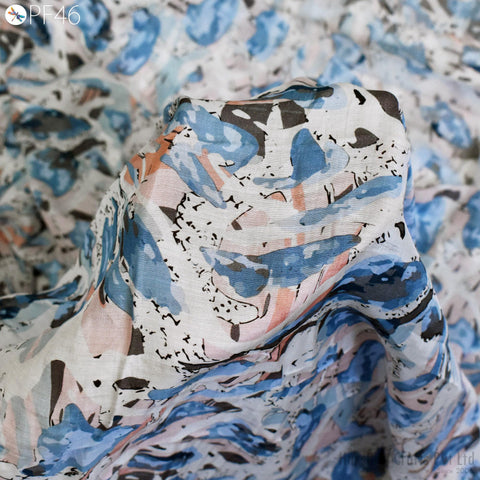 a close-up view of a fabric with a colorful, abstract pattern in shades of blue, pink, and white.