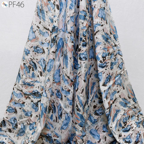 a close-up view of a fabric with a floral pattern in shades of blue, white, and black.
