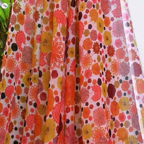 a close-up view of a fabric with a vibrant floral pattern, featuring a variety of colorful flowers and leaves.
