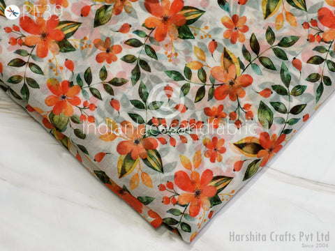 a fabric with a floral pattern, including orange and green flowers and leaves. The fabric appears to be printed on a white background, and there is a watermark in the bottom right corner that reads "Indianafabric".