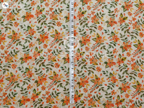 a fabric with a floral pattern, featuring various shades of orange and green flowers and leaves. A ruler is placed vertically in the center of the fabric, indicating the size of the fabric.
