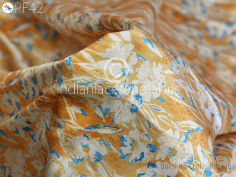 a close-up view of a fabric with a floral pattern in shades of orange and white.