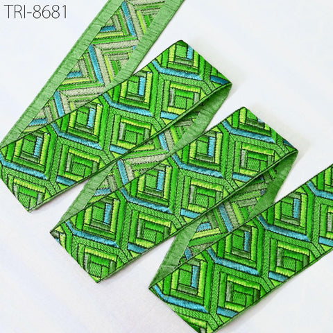 a close-up view of a green and blue geometric patterned fabric, possibly a decorative trim or ribbon.
