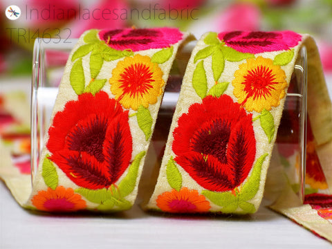 two colorful fabric ribbons with vibrant floral designs, including red, yellow, and green flowers, as well as leaves.