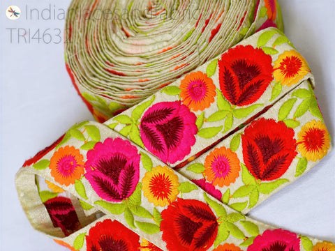 a close-up view of a colorful, embroidered fabric with a floral pattern. The fabric appears to be a decorative piece, possibly used for clothing or home decor.