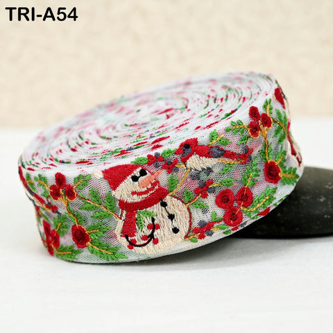 A close-up image of a decorative ribbon with a snowman design and red flowers.