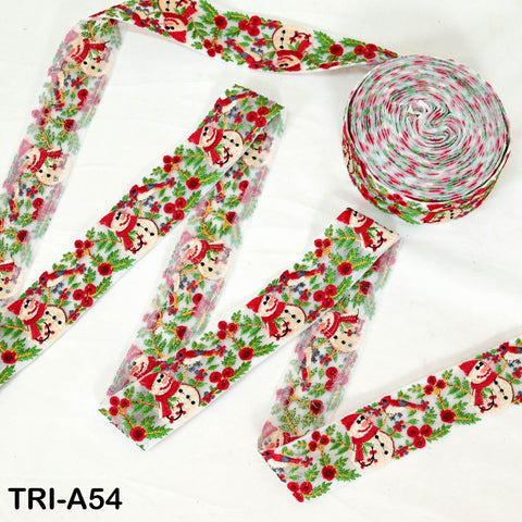 a collection of Christmas-themed ribbons and a spool of ribbon on a white background.