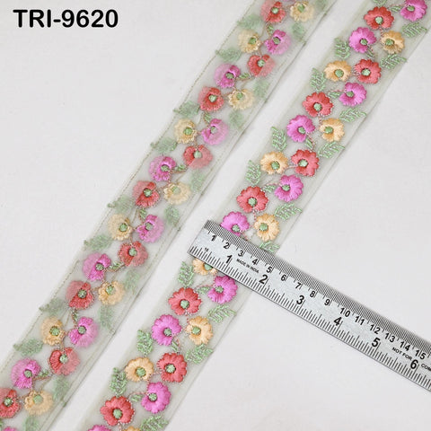 a decorative fabric with a floral pattern, featuring a ruler placed on top of it to measure the length.