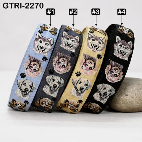 a collection of four colorful embroidered dog bandannas, each with a unique design and color scheme.
