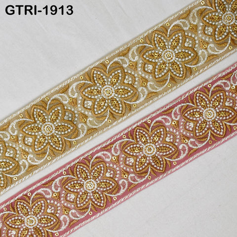 two decorative fabric pieces with intricate floral patterns in gold and pink colors. The pieces appear to be made of a shiny material, possibly silk or lace, and are arranged side by side on a white background.
