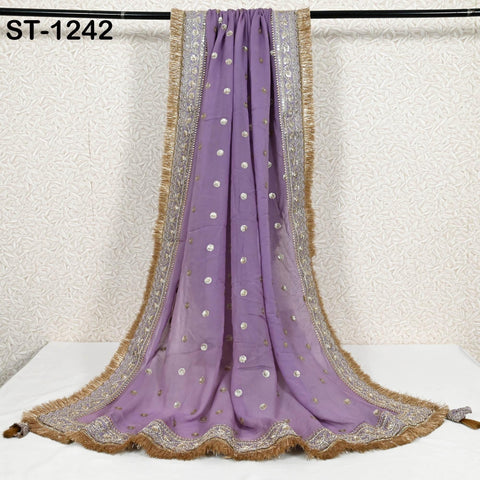 a long, purple, and gold embroidered shawl or scarf hanging on a black rod.
