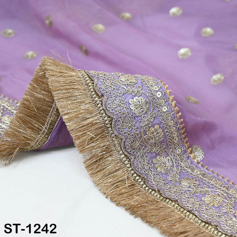 a close-up view of a purple fabric with intricate gold embroidery and a fringe design. The fabric appears to be a piece of clothing or textile, possibly a shawl or a blanket.
