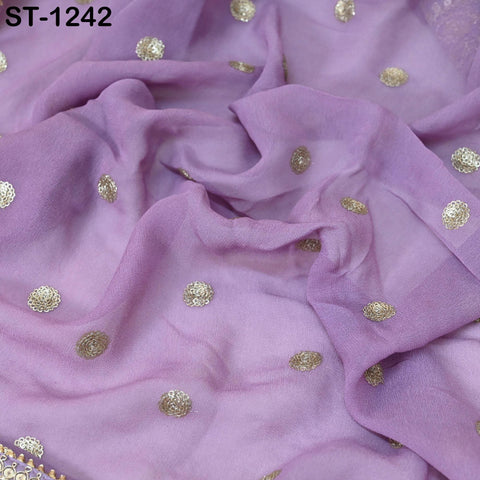 a close-up view of a purple fabric with small gold circular embellishments scattered across it.