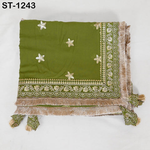 a green and gold embroidered fabric with a decorative border, featuring small white star-shaped embellishments.