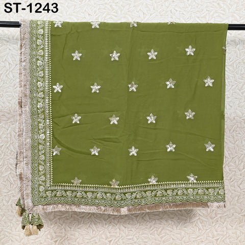 a green fabric with white star patterns, hanging on a rack.