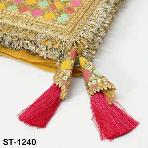 a close-up view of a decorative fabric with a gold and pink color scheme, featuring a tassel with red and pink tassels.