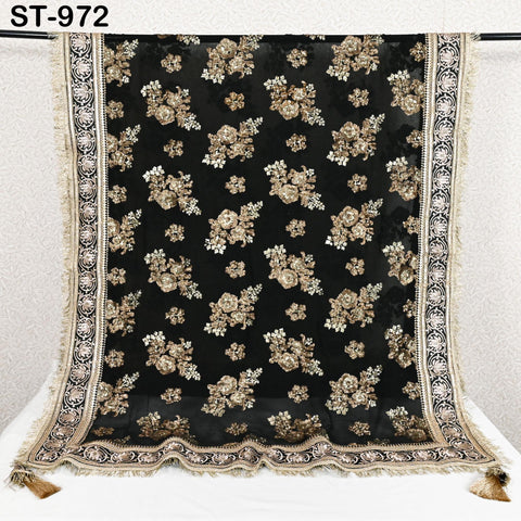 a black and gold floral embroidered fabric with a decorative border.