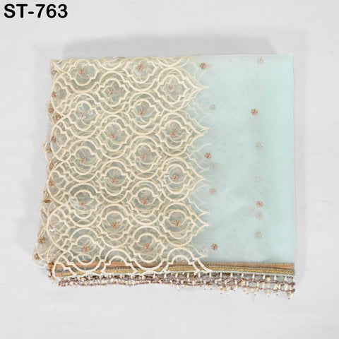 a decorative fabric with a lace-like pattern and a beaded trim. The fabric appears to be a light-colored material with a delicate, intricate design.