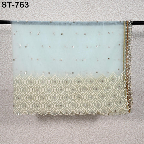 a light blue fabric with a delicate white lace trim, hanging on a wall.