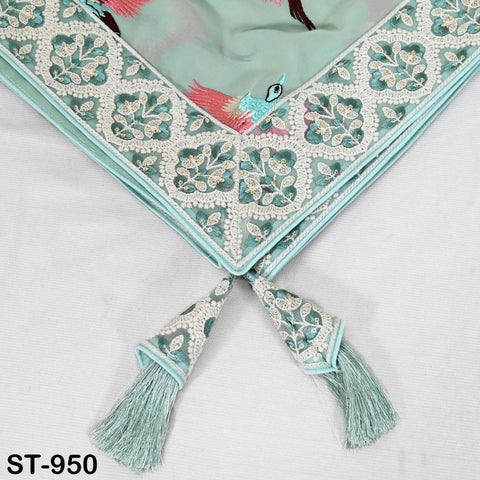 a decorative fabric with a floral pattern and tassels, placed on a white surface.