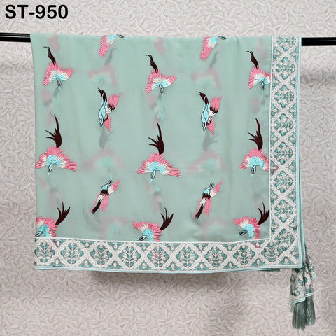 a light green fabric with a repeating pattern of pink and blue birds. The fabric is hanging on a metal bar, and there is a white border around the edge of the fabric.