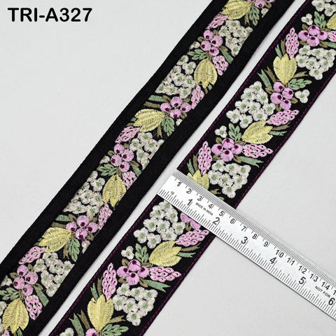 a decorative fabric with a floral pattern, featuring a black border and a ruler for size reference.