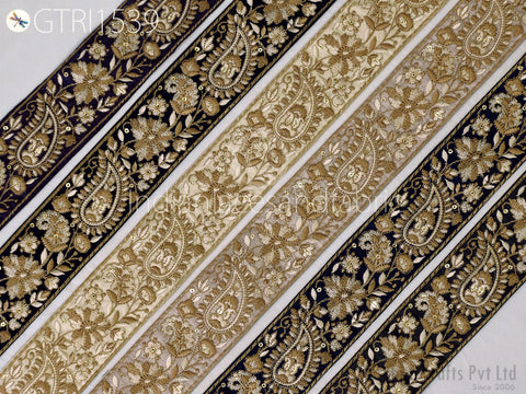 a collection of decorative fabric pieces with intricate paisley patterns in shades of gold and black. The fabric appears to be a decorative textile, possibly used for embellishment or as a decorative element in clothing or home decor.