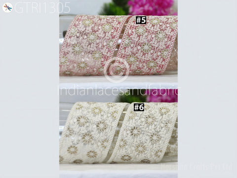 two fabric pieces with intricate floral patterns, one in pink and the other in white.