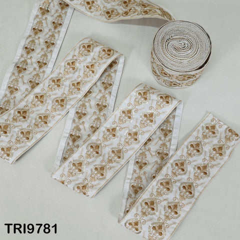 a collection of decorative fabric pieces with a repeating pattern of gold and white floral designs. The fabric appears to be a type of ribbon or textile, with a white background and a gold-colored border.