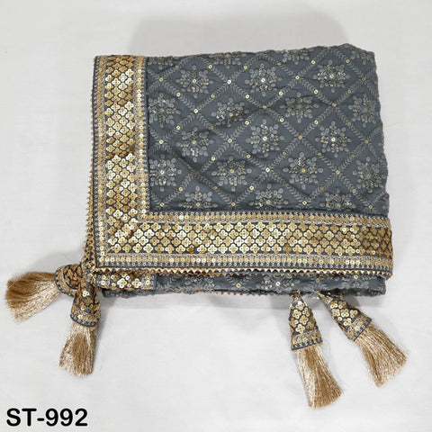 A gray and gold embroidered shawl with tassels, displayed on a white background.