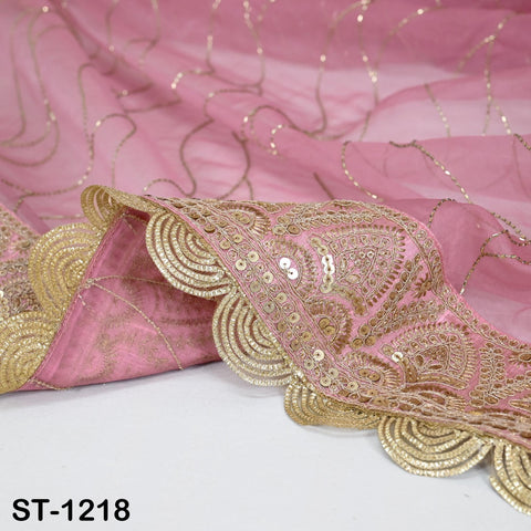 a close-up view of a pink fabric with intricate gold embroidery and a scalloped edge.