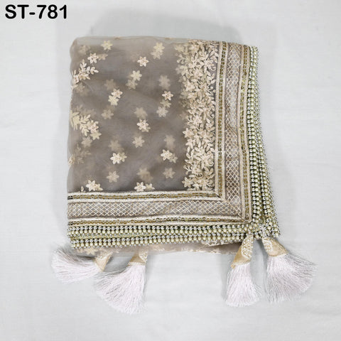 a decorative fabric with a floral pattern and tassels, placed on a white background.