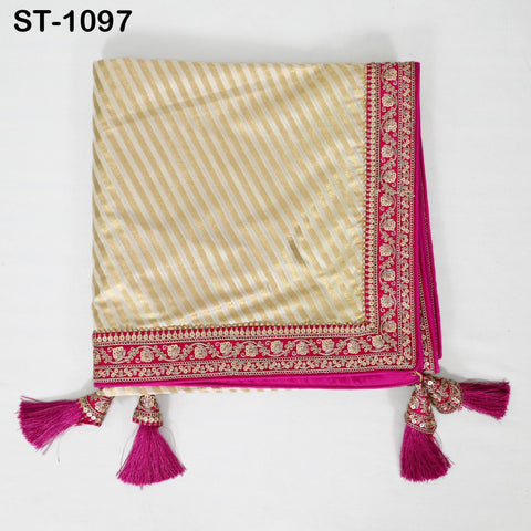 A decorative fabric with a striped pattern in gold and pink colors, featuring a decorative border with tassels and a matching border.
