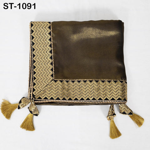 A brown fabric with a gold and black zigzag pattern, featuring tassels at the bottom.