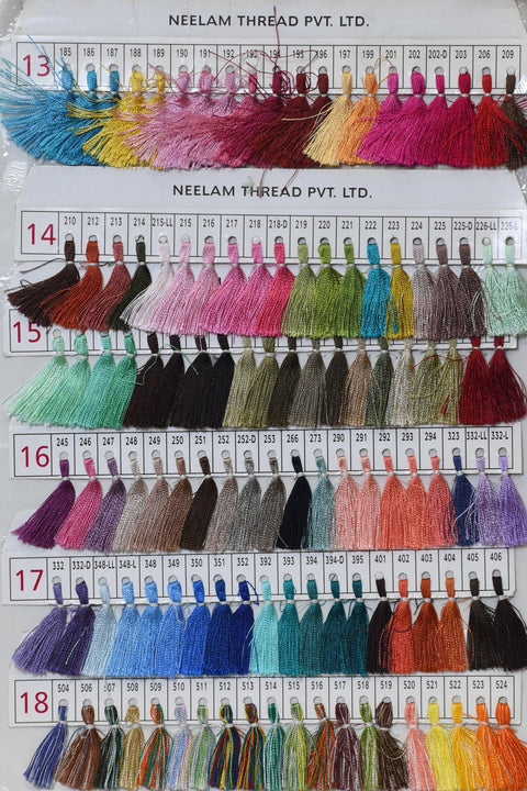 a collection of various colored thread samples arranged in rows and columns, likely for a sewing or textile project.
