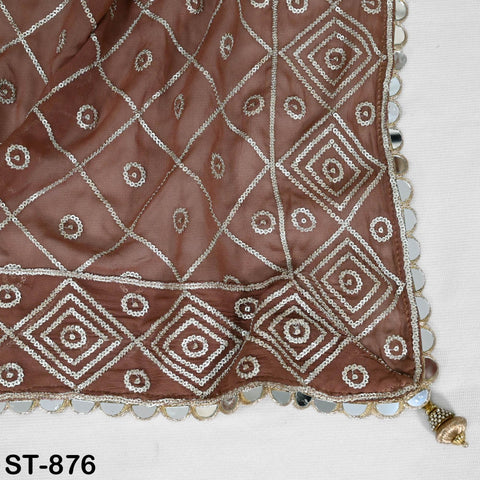 a close-up view of a brown fabric with a diamond pattern and small white circles, possibly a decorative piece or a textile.