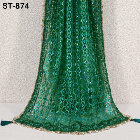 a long, green, sequined shawl with a gold trim.