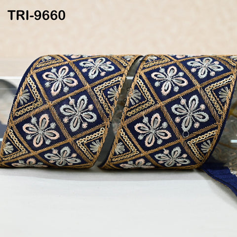 two ornate, decorative fabric pieces with intricate floral patterns in shades of blue and gold.