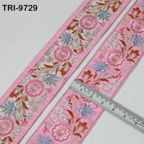 two pieces of pink fabric with intricate floral embroidery. A ruler is placed on the fabric, indicating the size of the fabric.