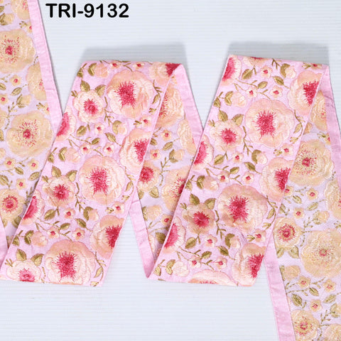 a pink fabric with a floral pattern, including pink and white flowers and leaves. The fabric appears to be a decorative piece, possibly used for clothing or home decor.