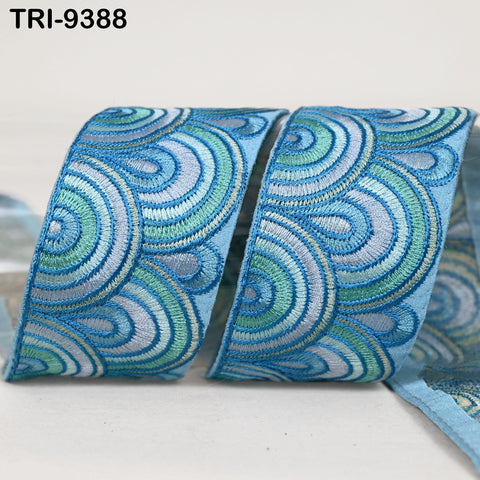 a close-up view of a decorative blue and green embroidered ribbon.