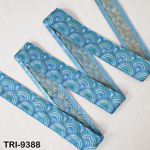 a collection of blue and green patterned fabric pieces, including a long piece of fabric with a repeating wave pattern and a shorter piece of fabric with a similar wave pattern.