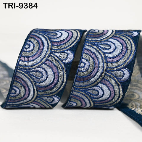 two pieces of fabric with a repeating pattern of blue and purple circles on a white background.