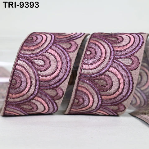 a decorative ribbon with a repeating pattern of pink and purple circles.