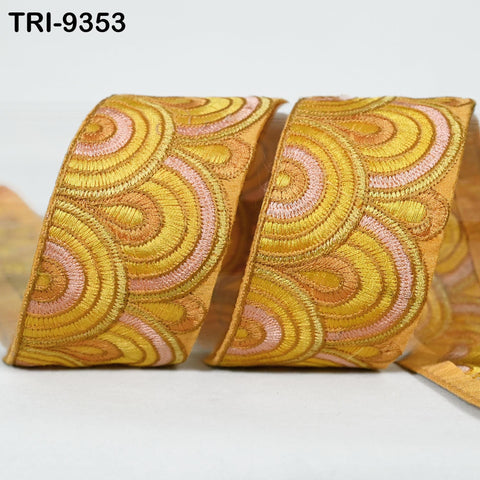 a close-up view of a decorative ribbon with a repeating pattern of yellow and pink circles.