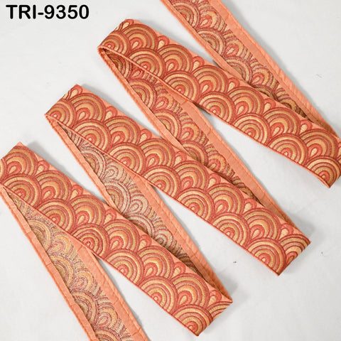 a collection of decorative fabric pieces with a repeating pattern of orange and red circles on a white background.
