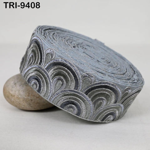 A gray and black patterned fabric, possibly a decorative trim or a headband, is shown in the image.